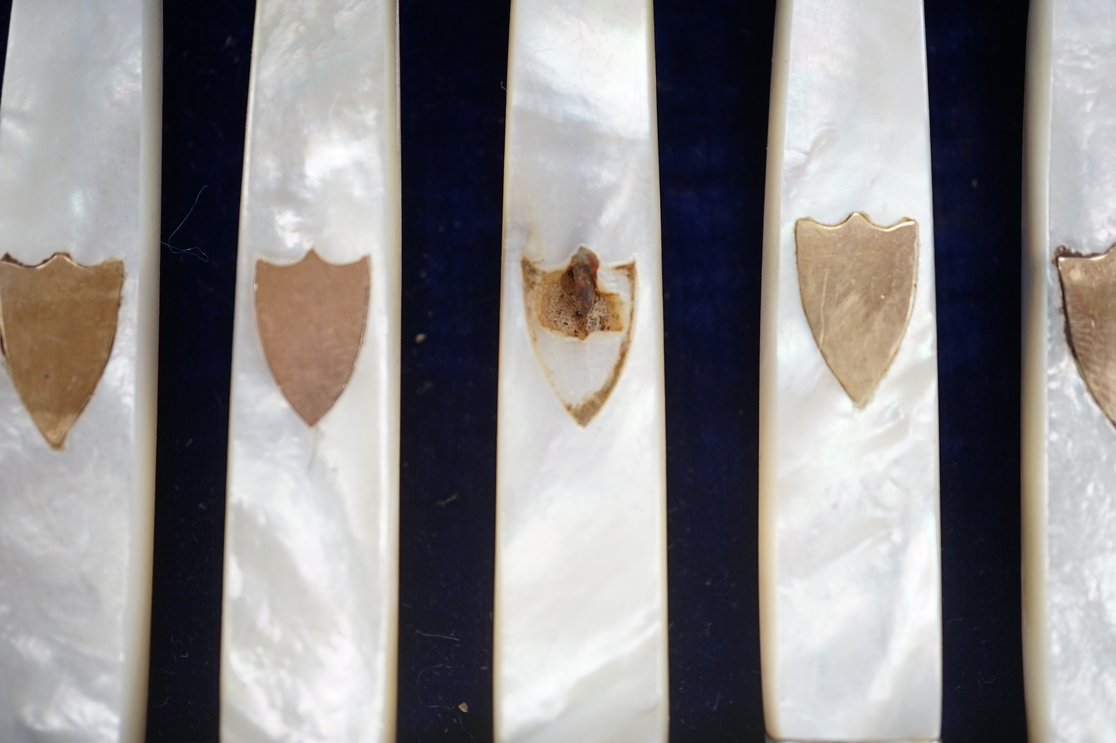 A cased set of twelve pairs of 19th century French mother of pearl handled white metal dessert eaters (one fork a.f.).